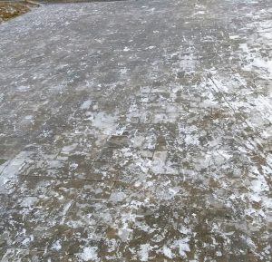 Sheet of ice on sidewalk